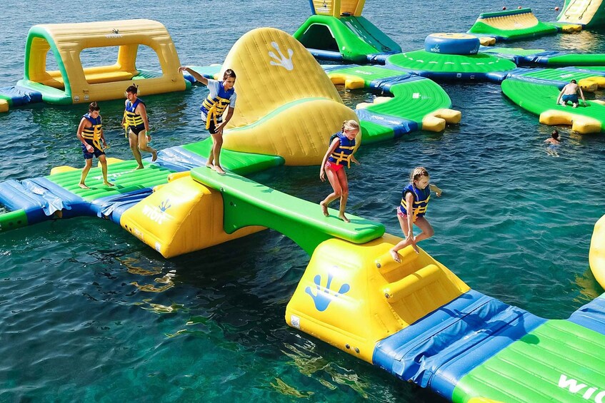 People on inflatable water structures in a body of water. 2