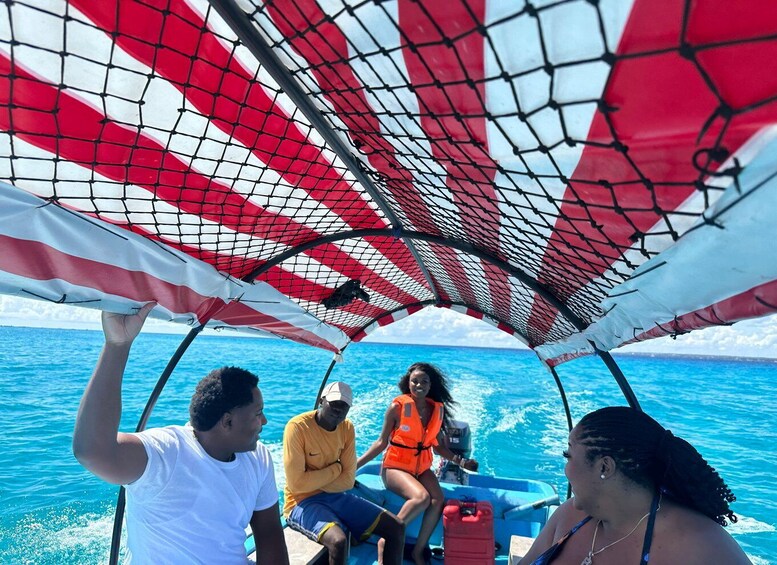A group of people on a boat with a canopy overhead. 3