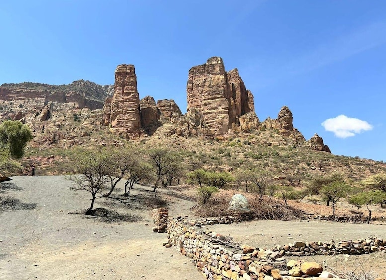 A desert landscape with prominent rock formations and sparse vegetation. 4