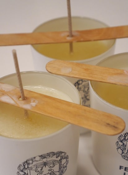Three mugs with wooden spoons, each containing a yellowish liquid. 2