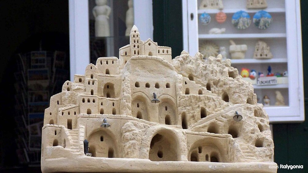 A detailed sandcastle model with multiple towers and arches. 4
