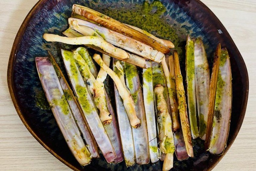 A dish of grilled asparagus with a green herb sauce. 5