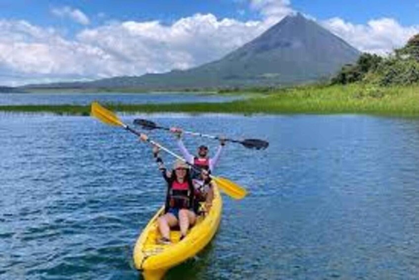 A yellow kayak on calm water with a mountain in the background. 3