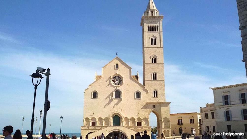 A historic church with a prominent bell tower and a large circular window. 3
