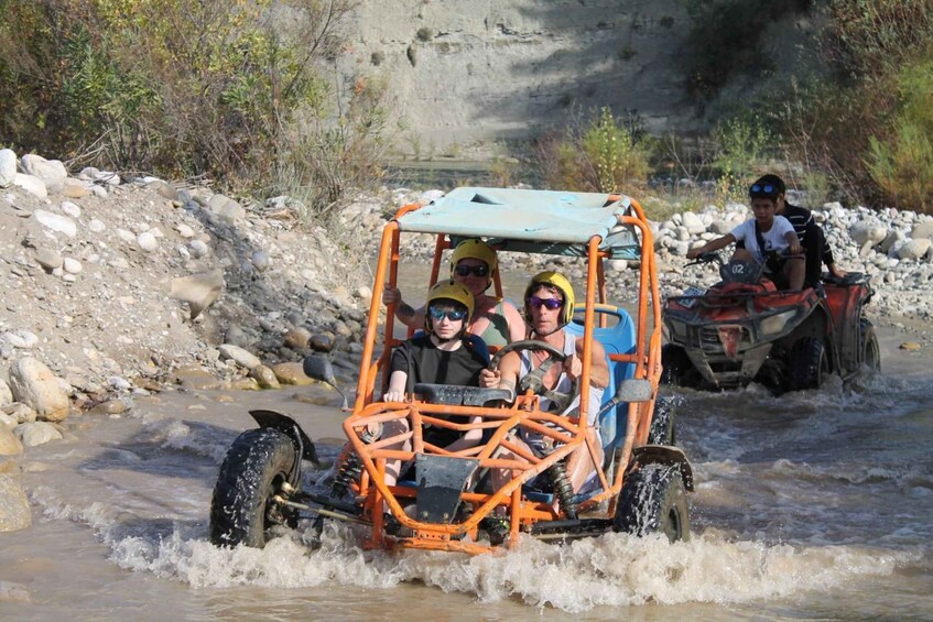 A group of people in a vehicle navigating a river. 3