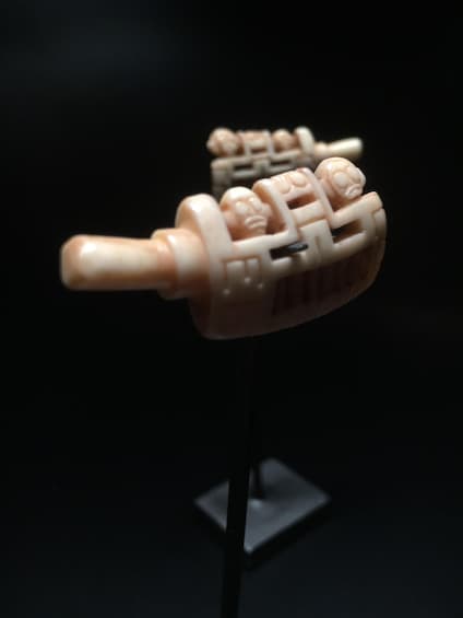 A model of a traditional Chinese medicine bottle with intricate carvings. 4