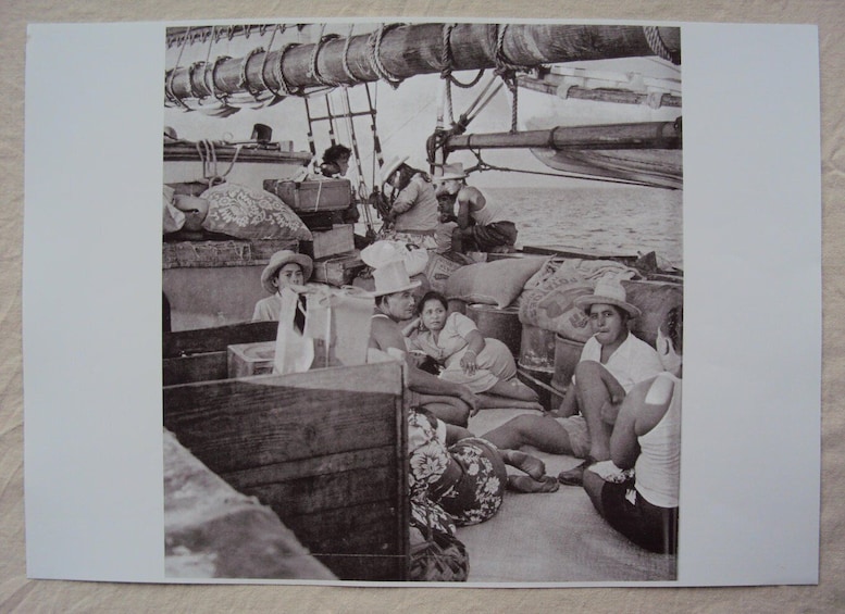 A group of people on a boat with cargo and equipment. 3
