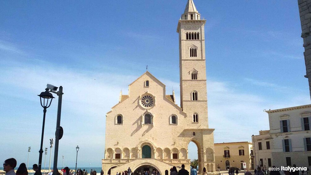 A historic church with a prominent bell tower and a large circular window. 1