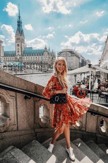 A person on a staircase overlooking a city with historic buildings and a prominent tower. 1