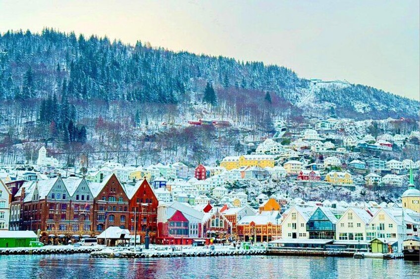 A snow-covered town with colorful buildings and a river. 3