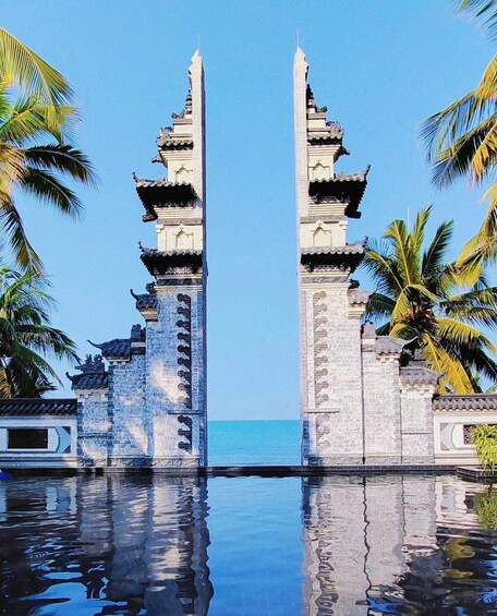 A traditional gate with multiple tiers and a clear view of the sea in the background. 1
