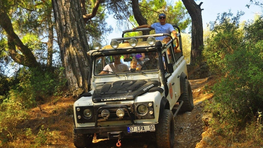 A Land Rover Defender vehicle on a forest trail. 5