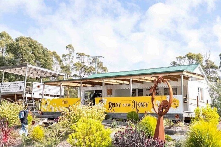 A building with a green roof and yellow signage reading 'Bruny Island Honey.' 3