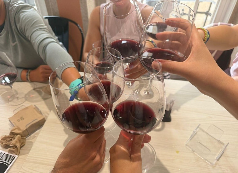 A group of people toasting with wine glasses. 3
