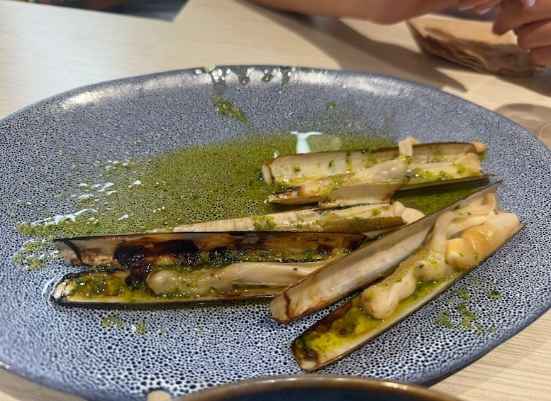 A plate with grilled asparagus and a green sauce. 2