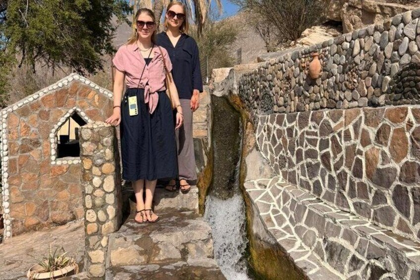 A stone staircase with a small house-like structure at the top, a stone wall with a decorative pattern, and a rocky ledge. 2
