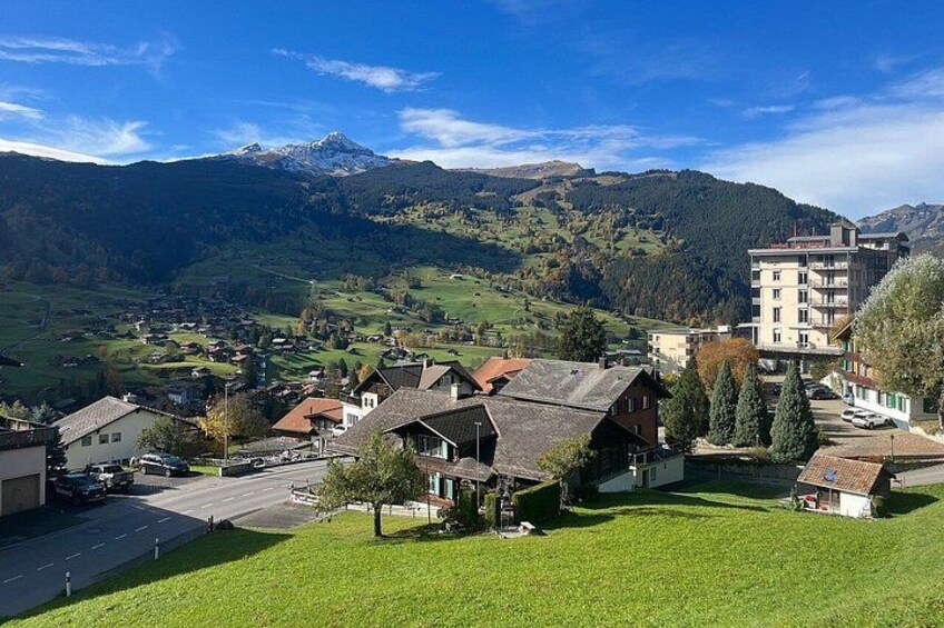 A village with houses, a road, and mountains in the background. 1