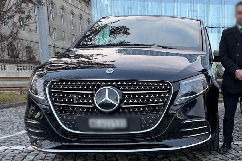 A black Mercedes-Benz SUV parked on a cobblestone street. 4