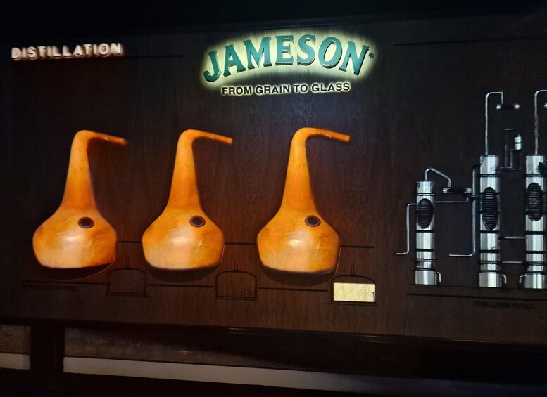 A distillation apparatus with three wooden stills and a metal condenser. 3