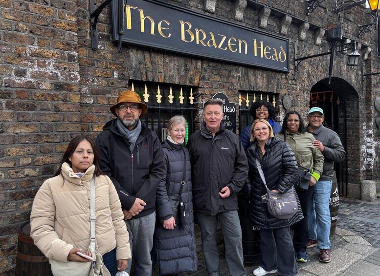 A group of people standing in front of The Brazen Head pub. 2