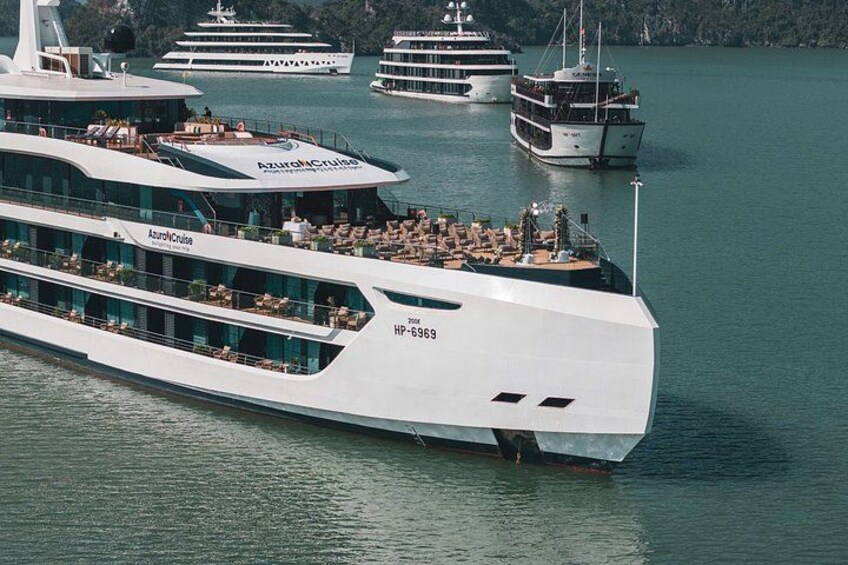 A large, modern cruise ship named AzurOceanCruise with multiple decks and passengers. 4