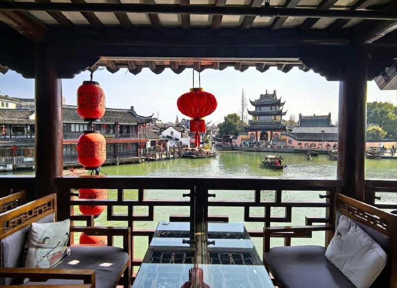 A traditional Chinese pavilion overlooking a river with red lanterns and classic architecture. 4