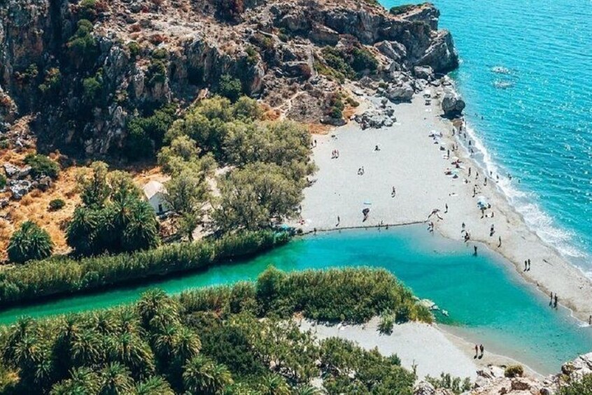 A coastal landscape with a beach, rocky cliffs, and a turquoise sea. 3
