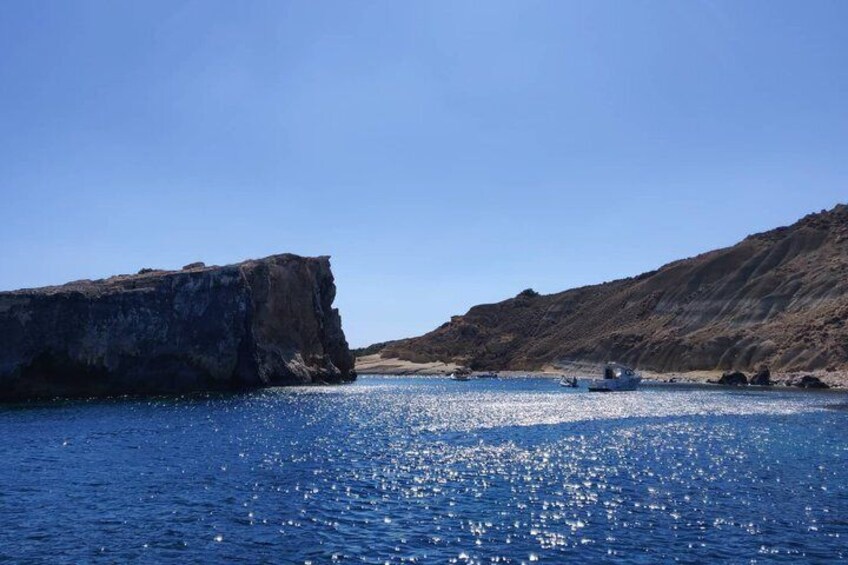 A coastal landscape with a large cliff and calm sea. 3