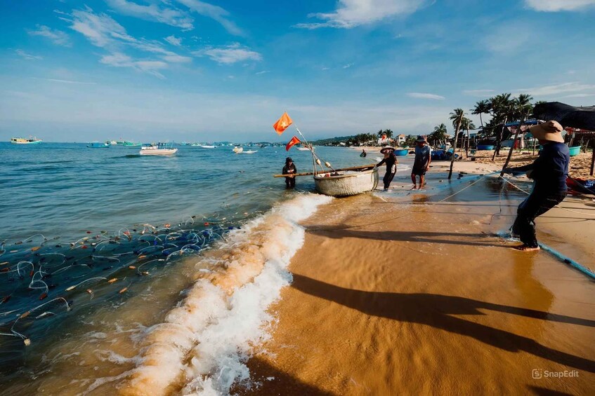 A beach with people fishing, boats, and palm trees. 1