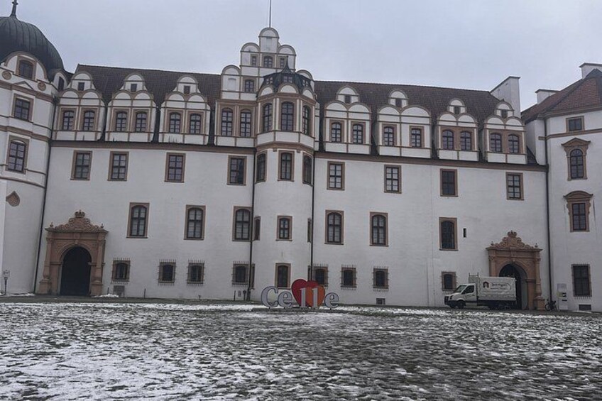 A historic building with a symmetrical facade, arched windows, and a central dome. 3