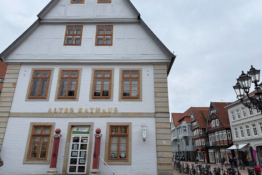 A white building with the sign 'ALTES RATHAUS' and a row of bicycles parked outside. 2