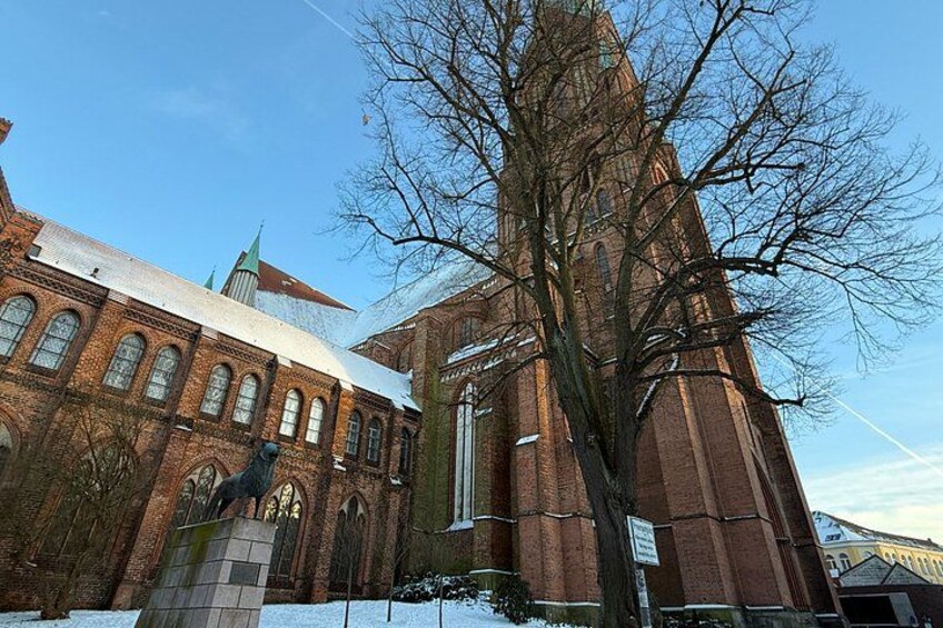 A brick building with arched windows and a tower. 3