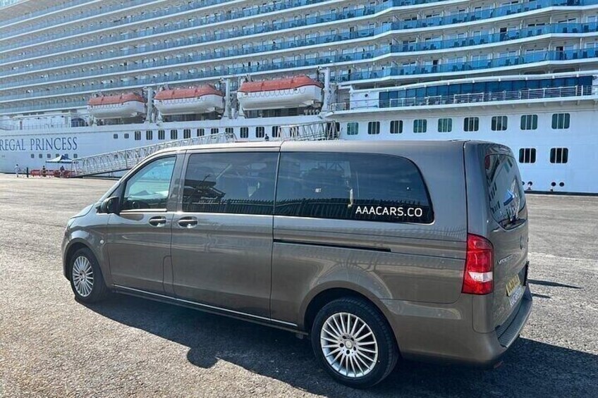 A brown van parked in front of a cruise ship named 'Regal Princess.' 2