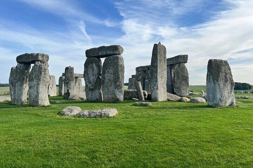 Stonehenge standing on a grassy field with clear skies. 1