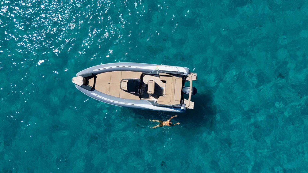 An aerial view of a boat on clear turquoise water. 1