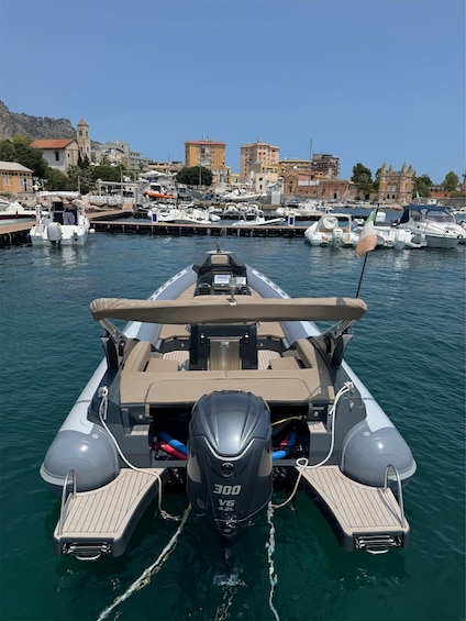 A motorboat docked at a marina with a cityscape in the background. 4