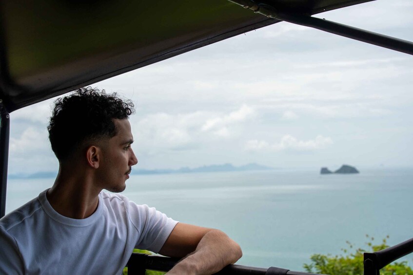 A person overlooking a body of water with distant landforms. 5