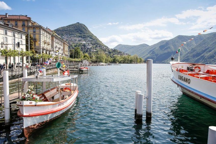 A boat docked at a pier with a mountainous backdrop. 5