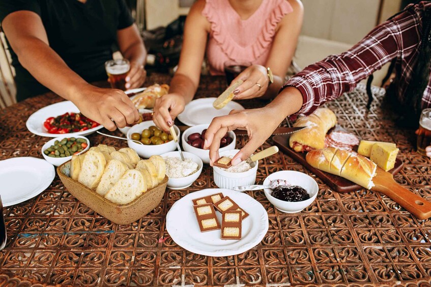 A group of people sharing a meal with various dishes and bread. 1