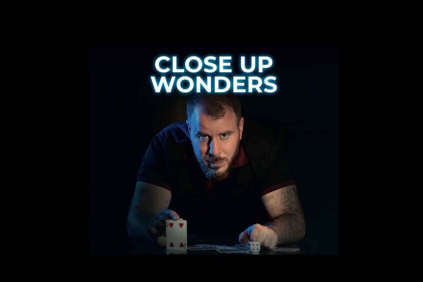 A person playing cards with a dark background and the text 'CLOSE UP WONDERS' at the top. 1