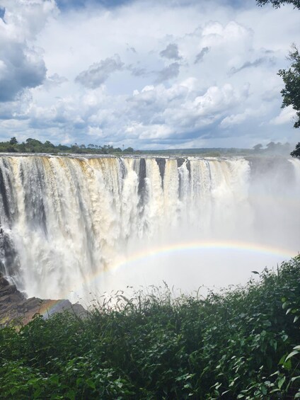 A waterfall with a rainbow. 1