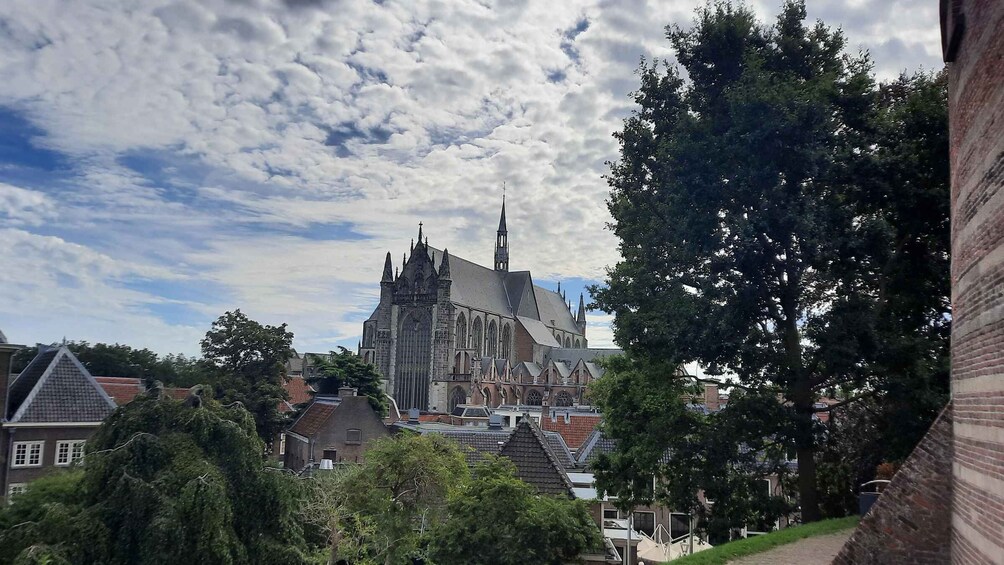 A historic church with a pointed spire, surrounded by residential buildings and trees. 3