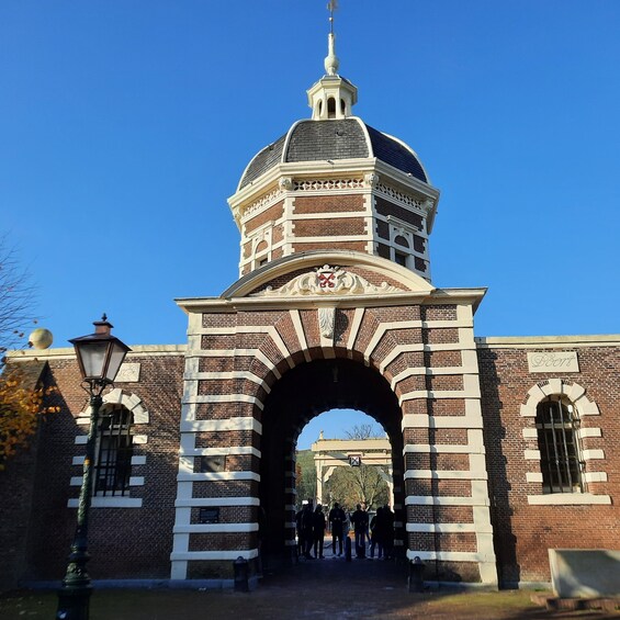 A brick archway with a dome and a clock tower. 2