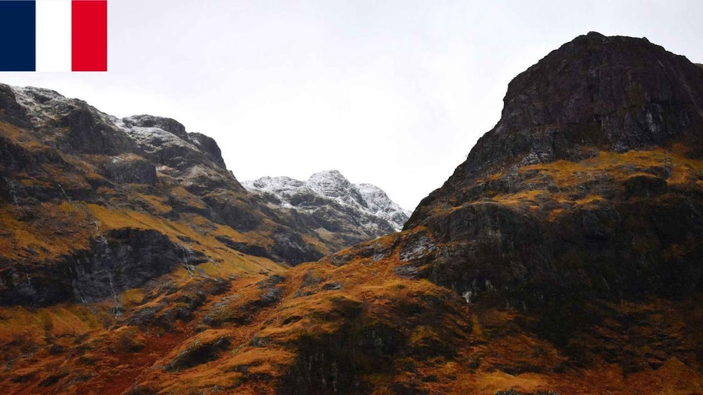 A mountainous landscape with rocky terrain and snow-capped peaks. 4