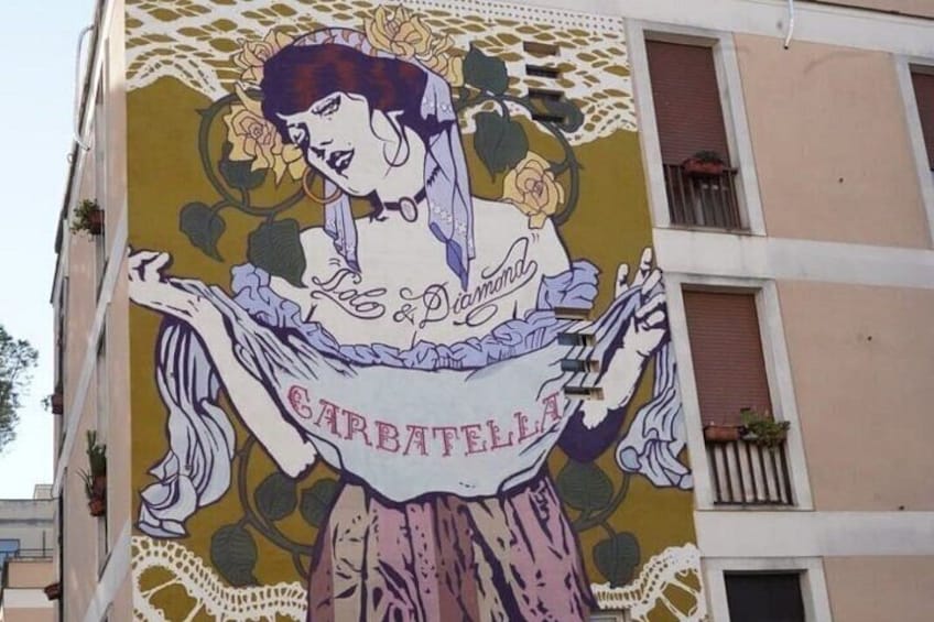 A mural of a woman with a rose, the words 'Le Plais' and 'CARBATELLA' on a building. 2