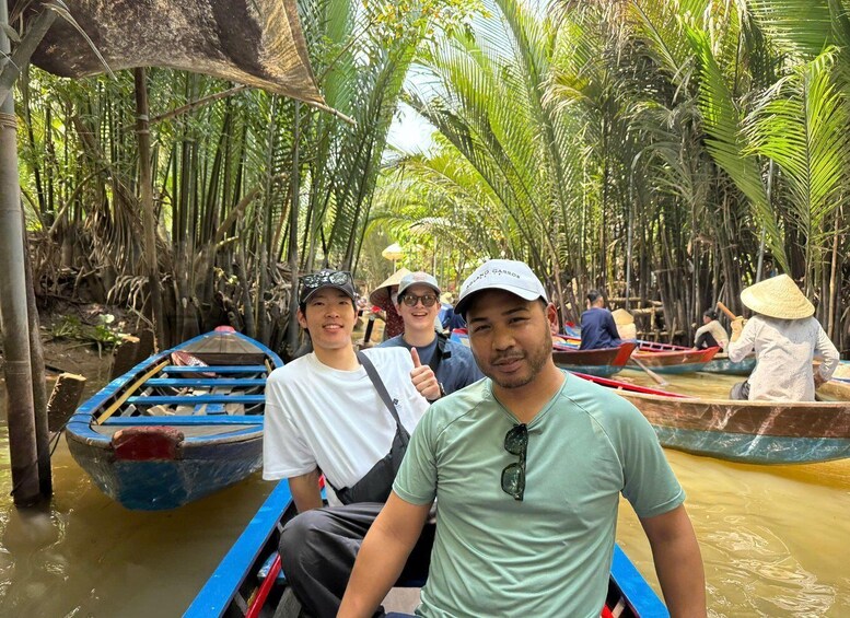 People in a boat on a river surrounded by dense tropical vegetation. 2