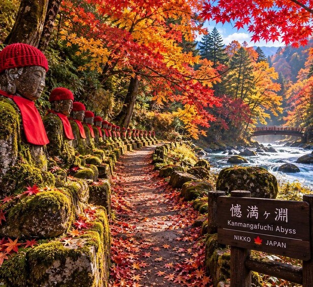A stone pathway lined with statues, a river, and autumn foliage. 4