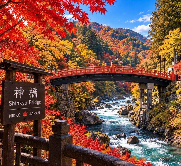 Shinkyo Bridge in Nikko, Japan, with a river below and autumn foliage. 5