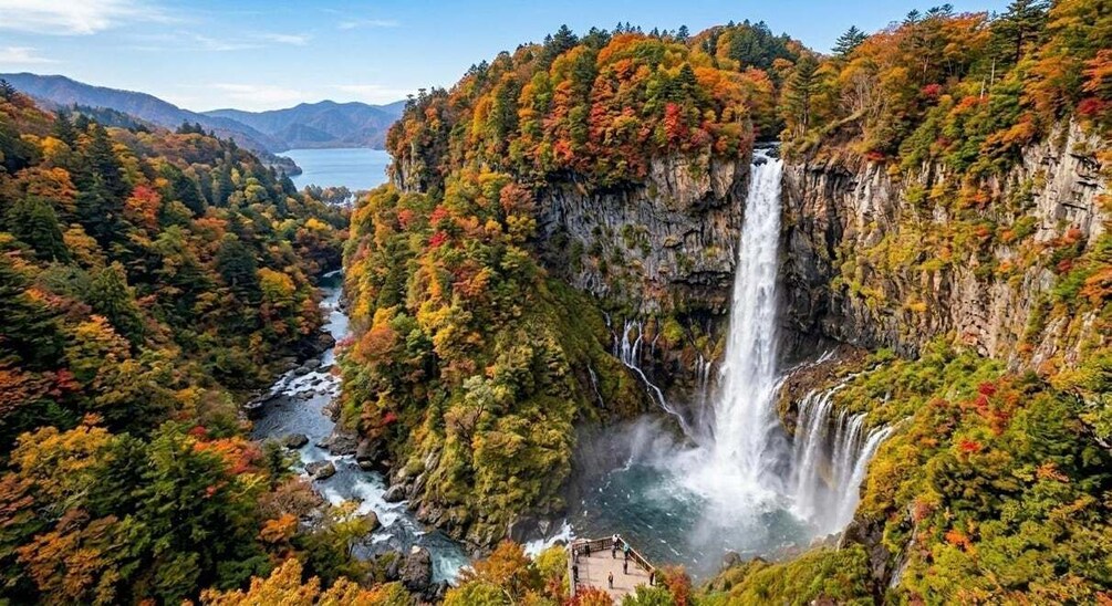 A waterfall cascading down a cliff surrounded by autumn-colored trees. 4