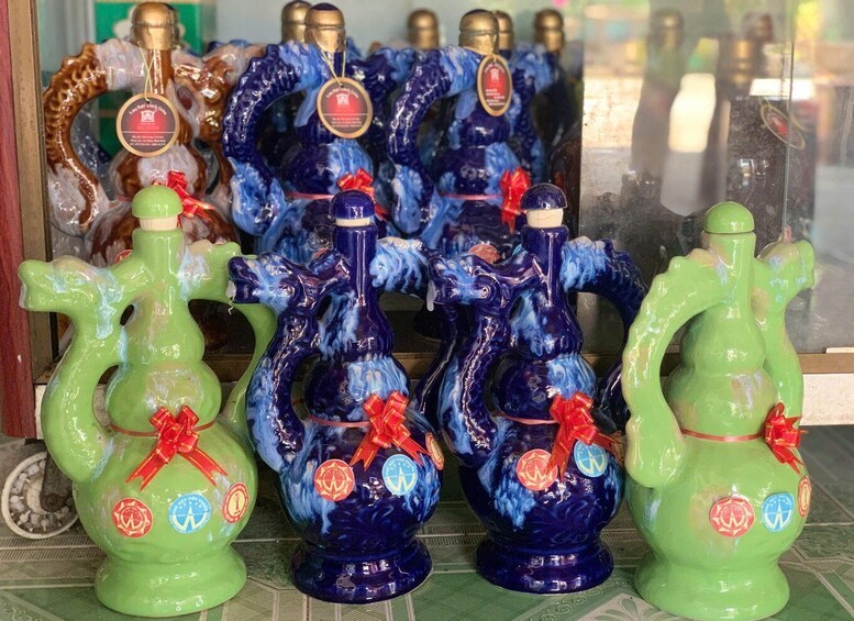 A display of decorative vases with ribbons and badges. 5